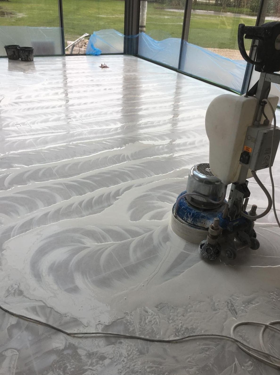 Rotary machine honing a stone floor during restoration